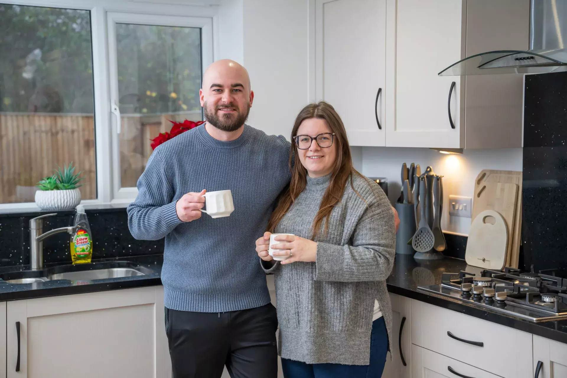 Newly moved in couple enjoying a cup of tea in their kitchen